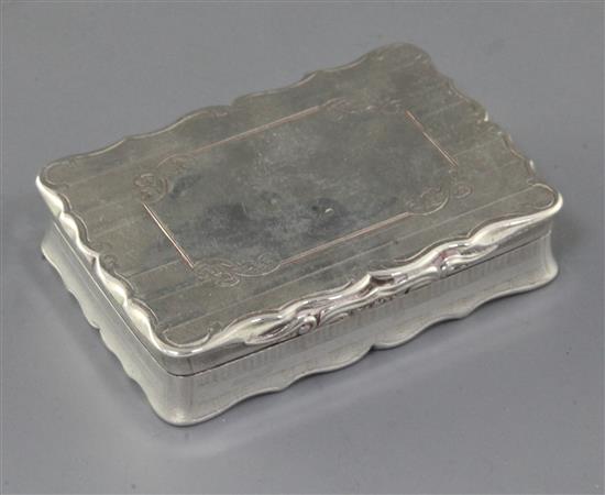 A Victorian engraved silver table snuff box by Nathaniel Mills, of shaped rectangular form, Birmingham 1851, 8.5cm.